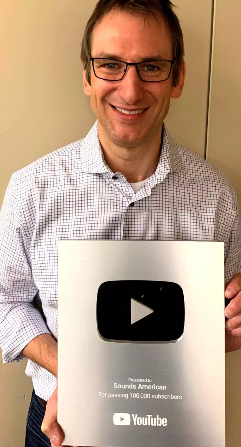 Darren Packard holding YouTube Silver Creator Award for Sounds American