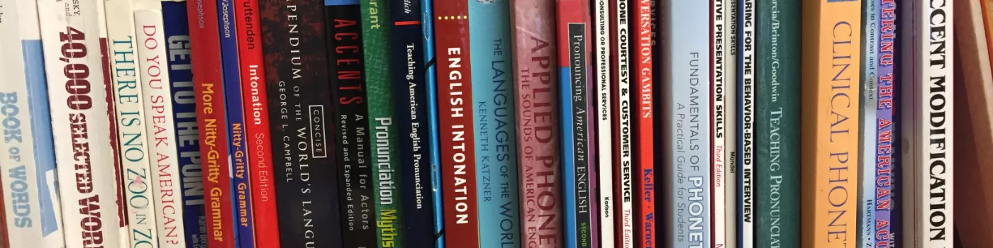 Bookshelf with books on accents, phonetics, and communication