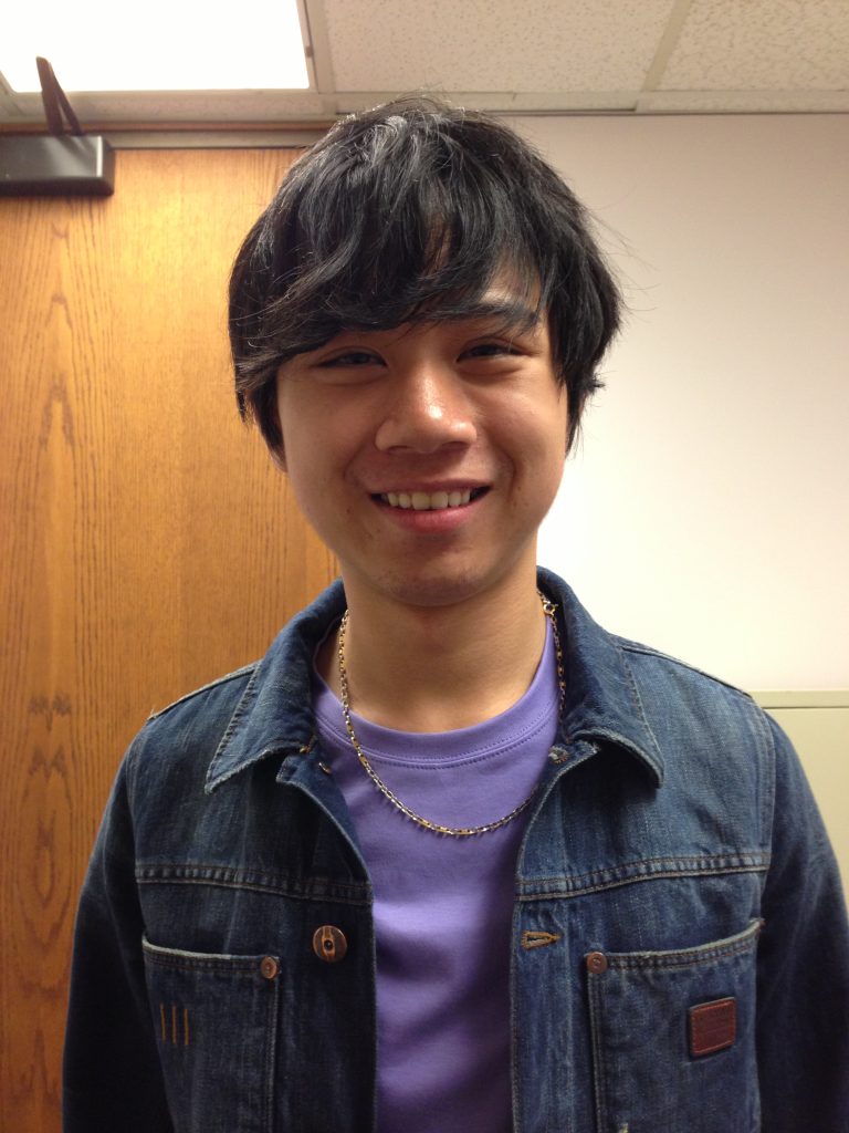 Smiling Japanese man in casual clothing, representing a Japanese speaker improving English pronunciation through japanese accent modification.