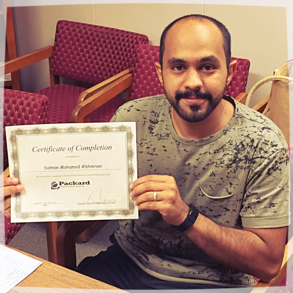 Adult male student holding a certificate of completion from Packard Communications after completing online accent modification training based in Portland Oregon.